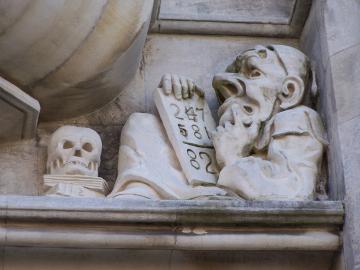 Picture of grotesque pondering a tablet of numbers