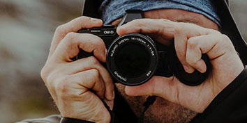 man holding a camera up to his face
